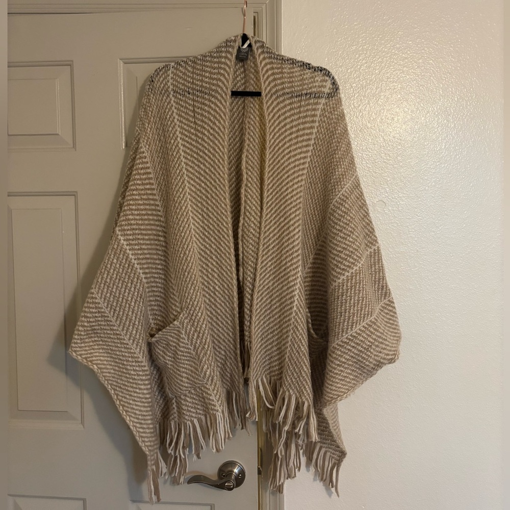 Tan and white shawl with fringe on the bottom